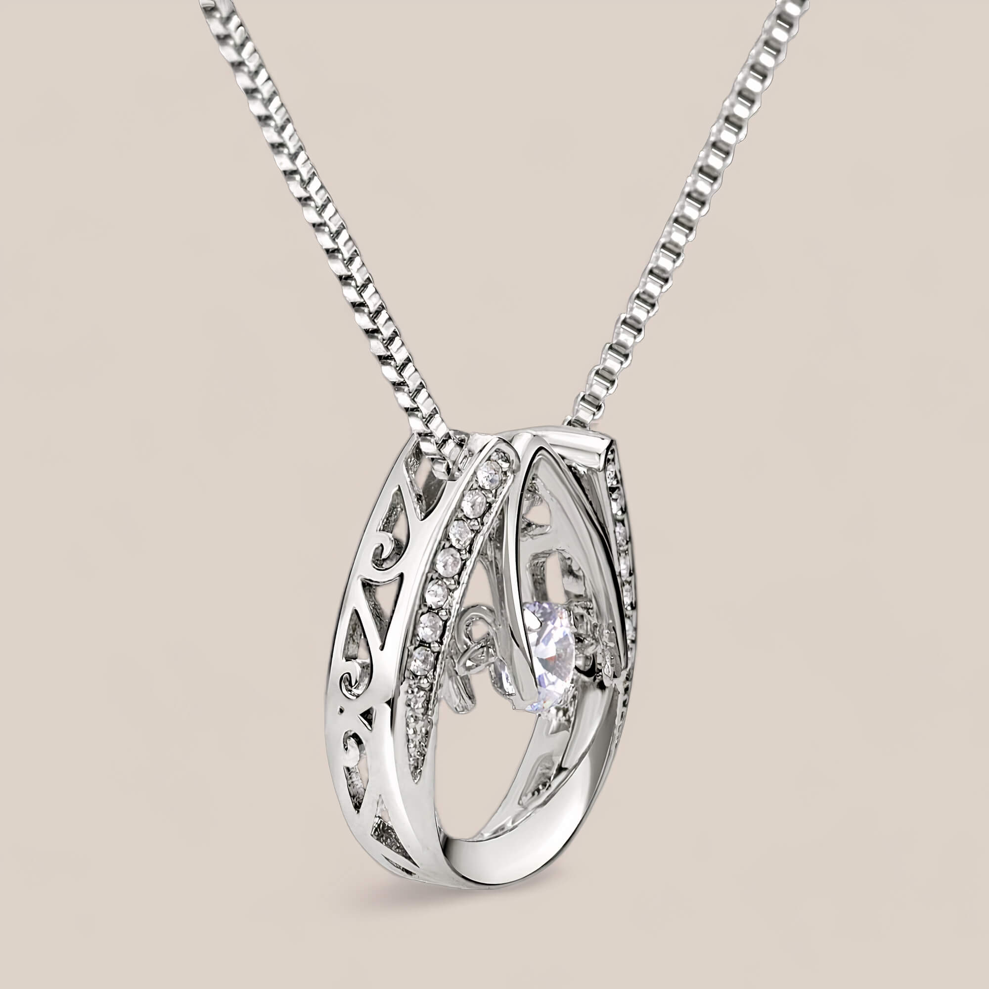 Side view of Abundance necklace, highlighting the intricate carvings along the sides of the pendant.