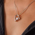 Side view of Passion necklace in 14k white gold finish worn on model.