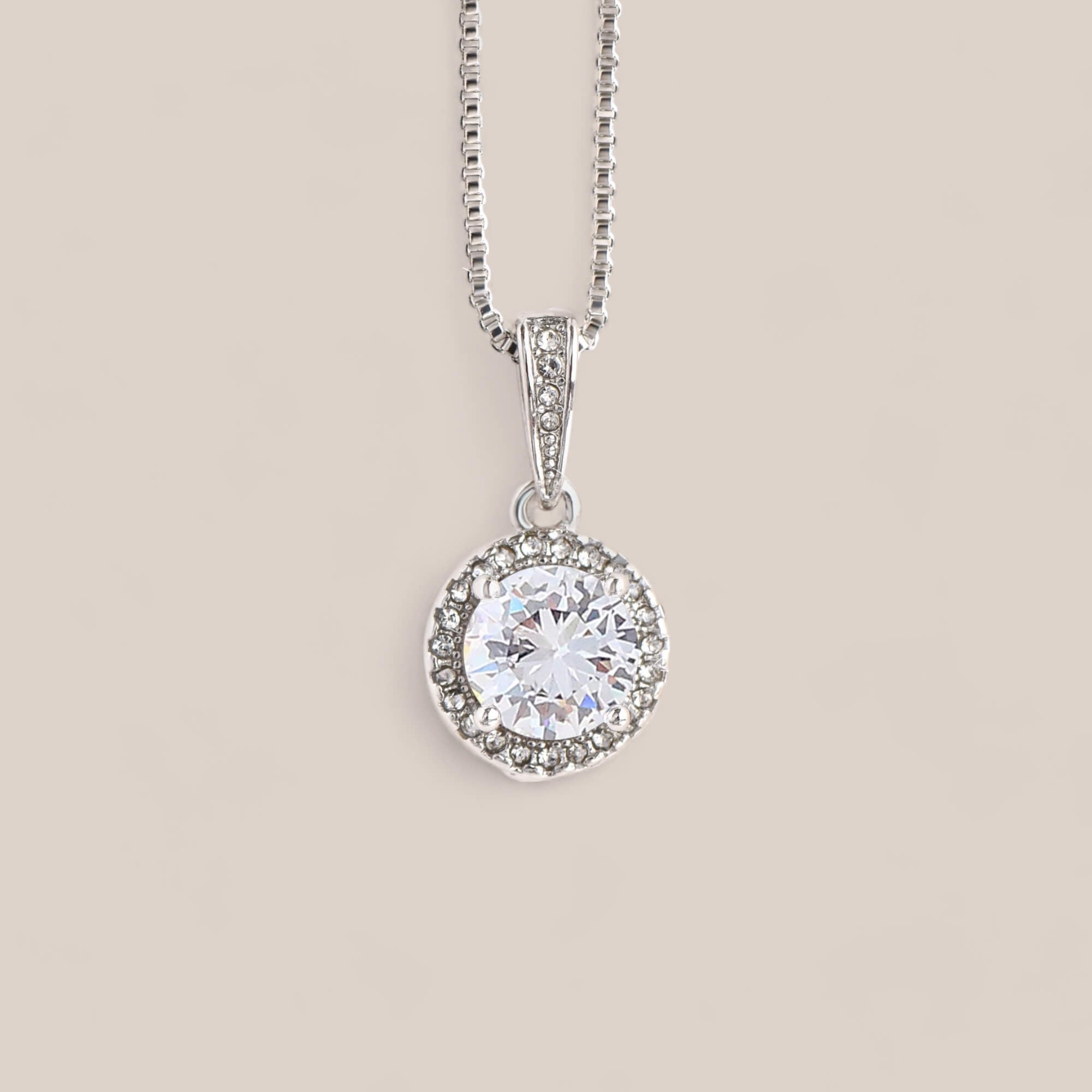 14k white gold-plated Prosperity necklace featuring a cushion-cut cubic zirconia crystal encircled by smaller accent crystals.