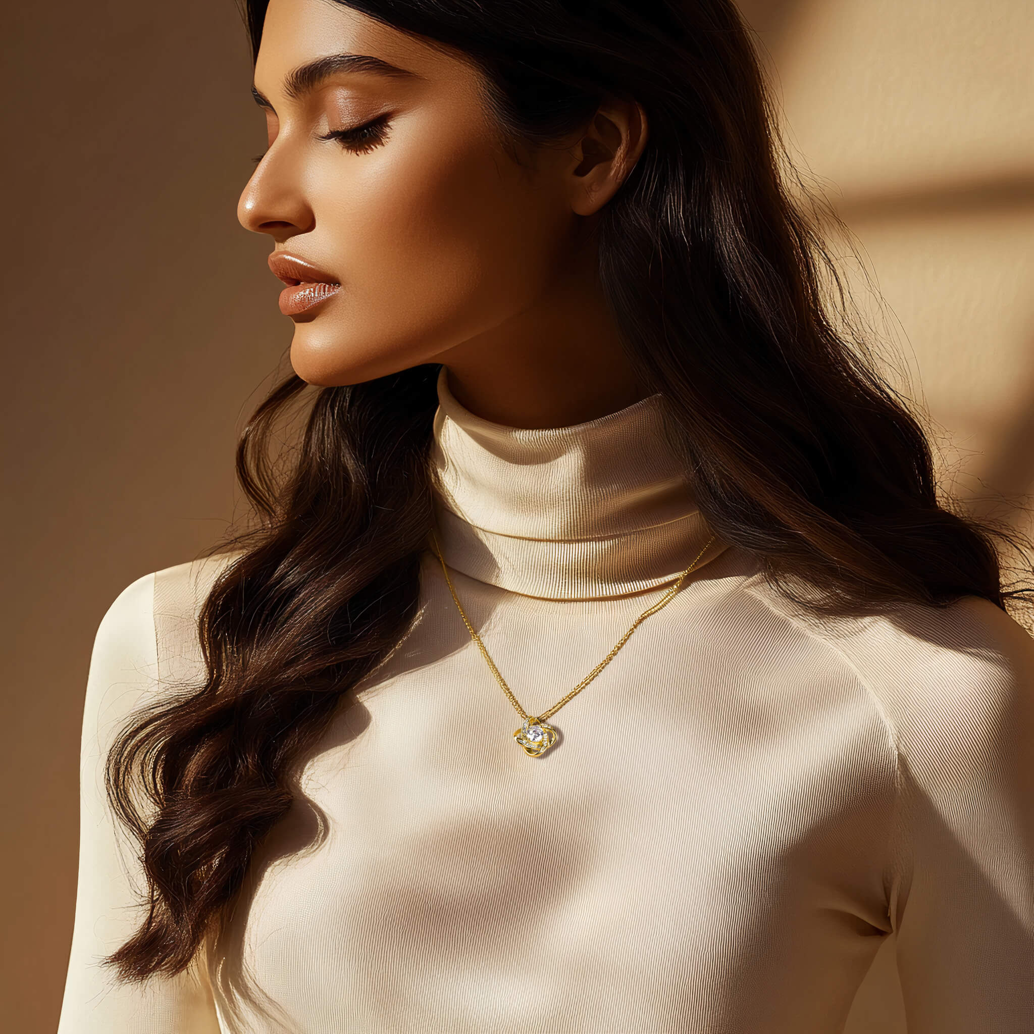 Model wearing Radiance necklace in 18k gold finish with an ivory turtleneck in warm natural light, showcasing the shimmering center crystal.